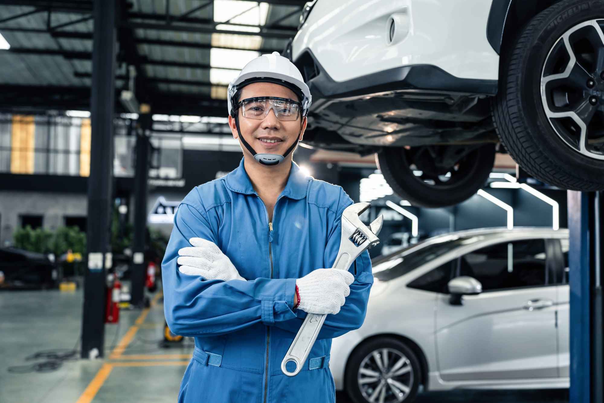 Portrait of Asian handsome automotive mechanic men standing in garage.